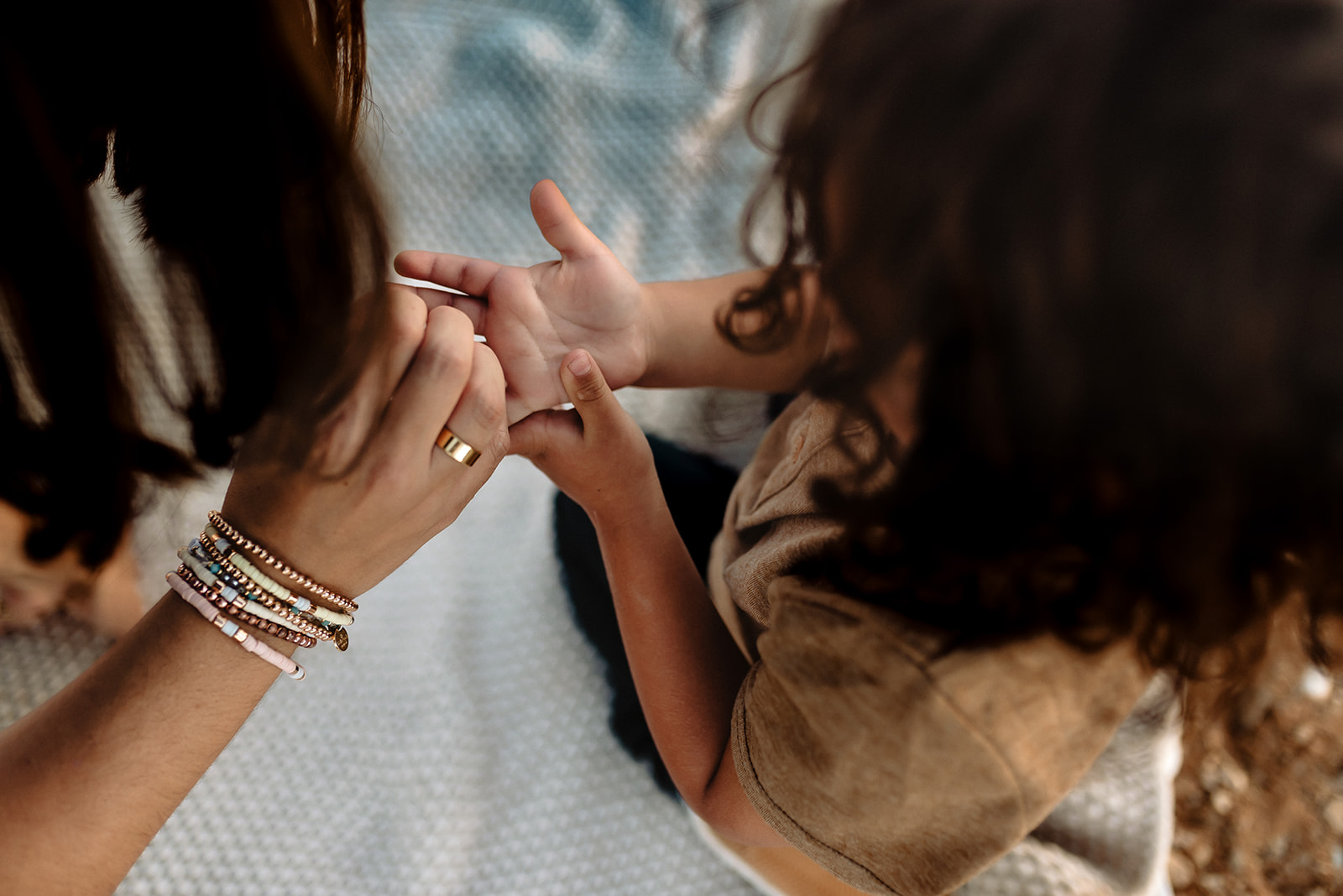 Mom looks at her little boy's hand.