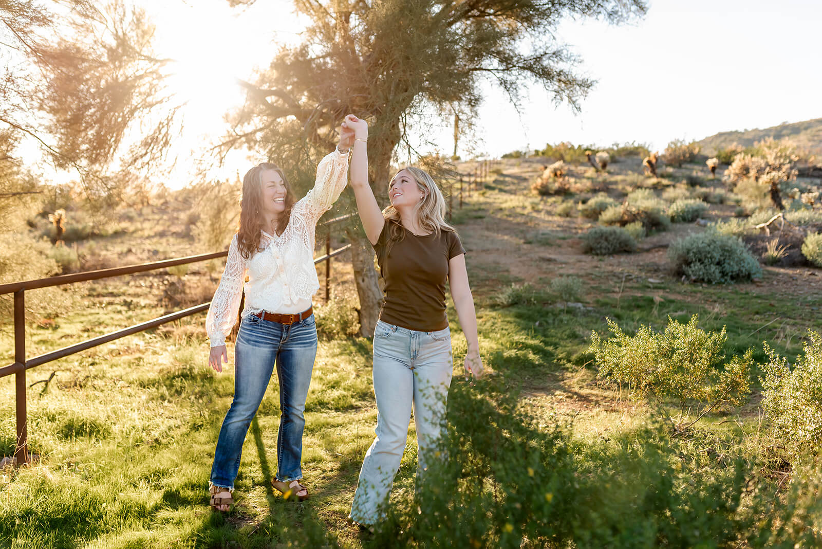 Mother and teenage daughter dance in a family photo session at Apache Wash Trailhead.
